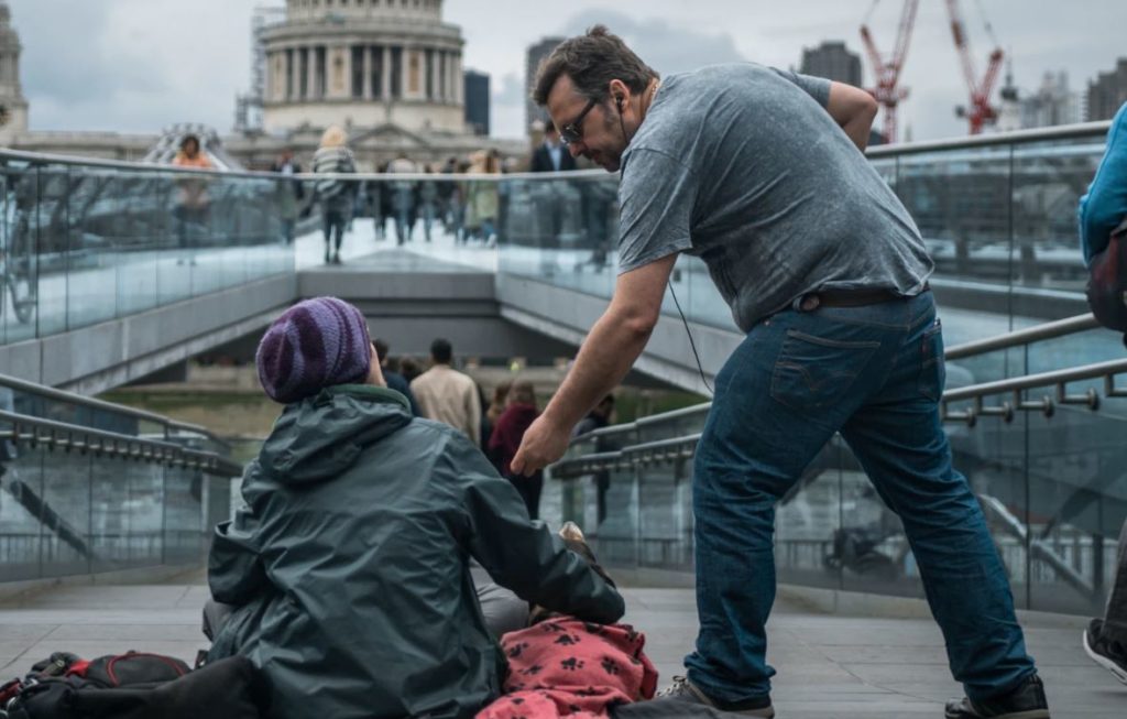 man giving to another person