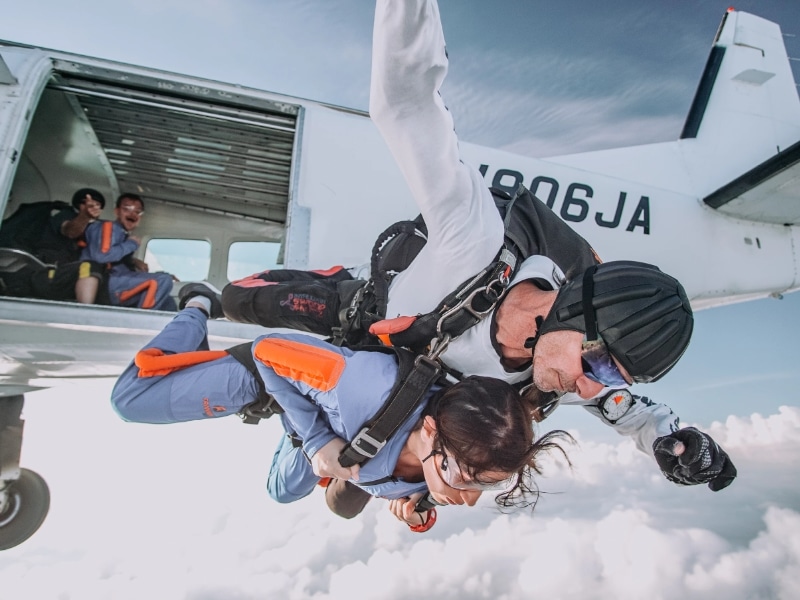 woman jumping out of plane skydive