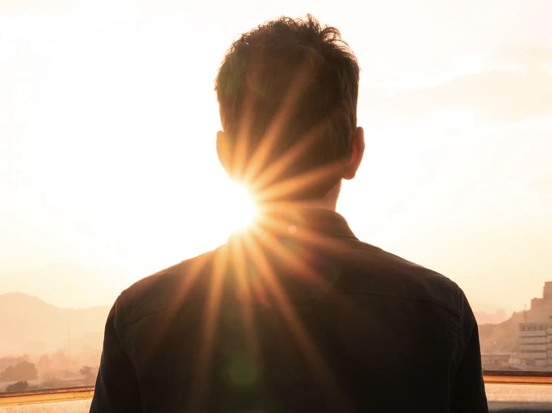man standing in sun silhouette