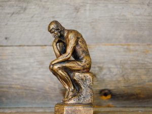 statue of man thinking