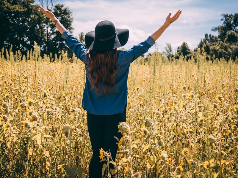 woman field flowers happy