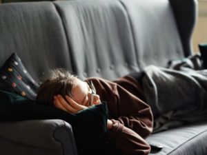 woman laying on couch watch tv