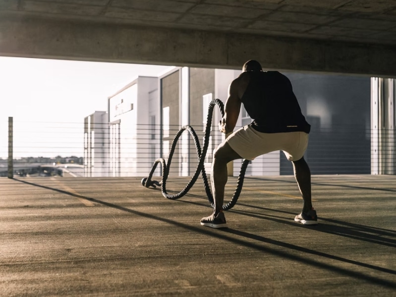 man exercising with ropes