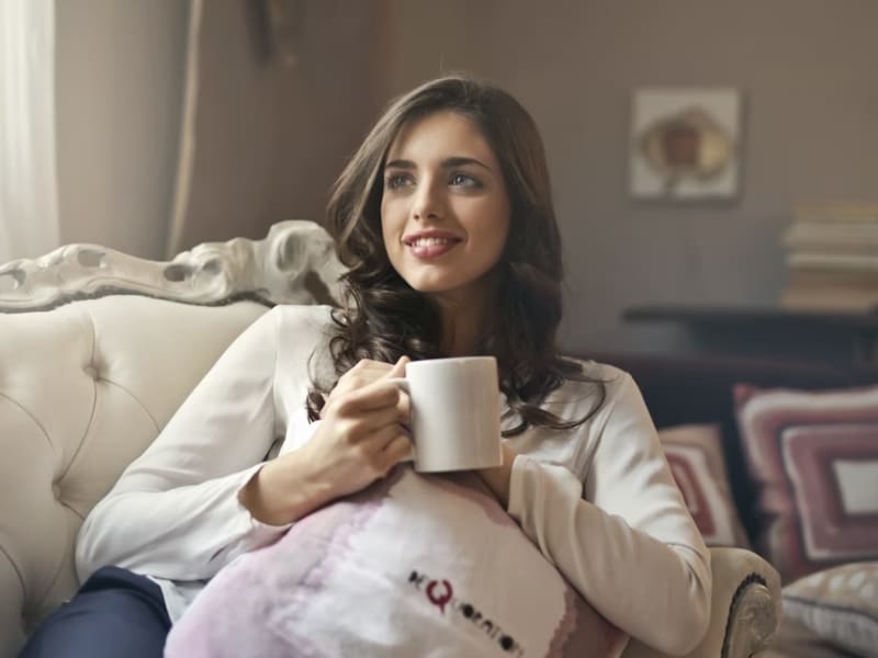 woman relaxing on couch with tea