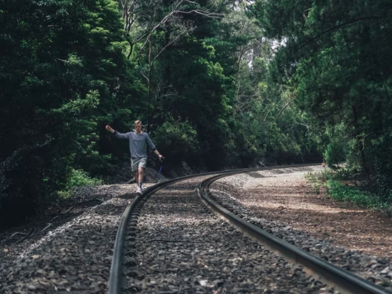 man walking on train track