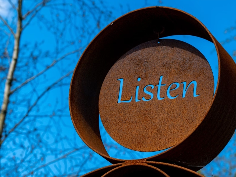 metal statue that says listen