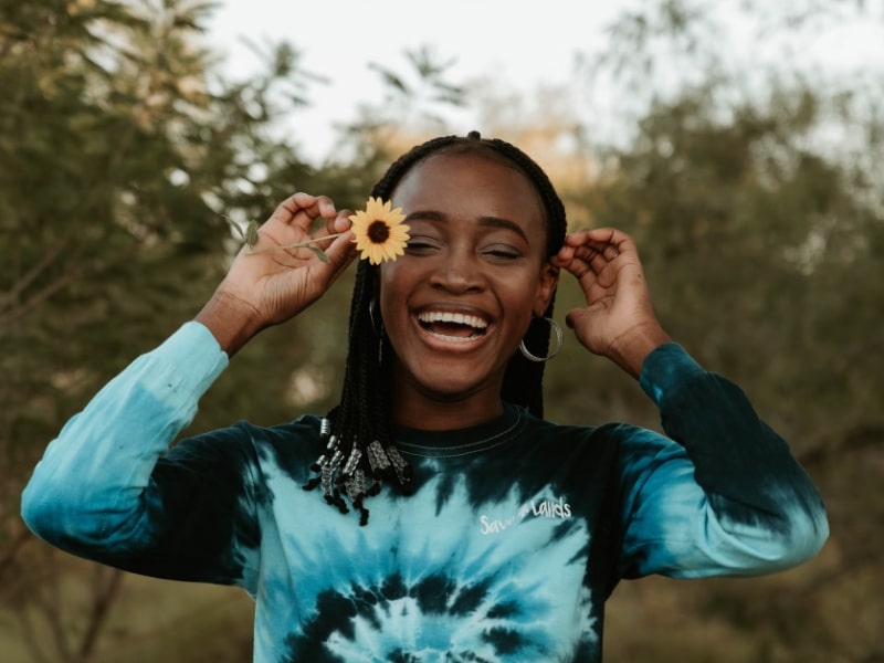 woman laughing with flower