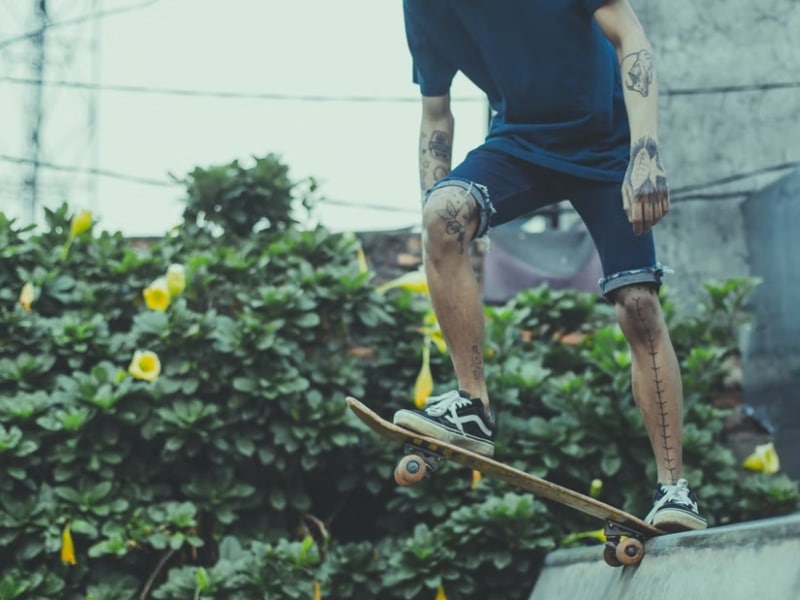 man dropping in on skateboard