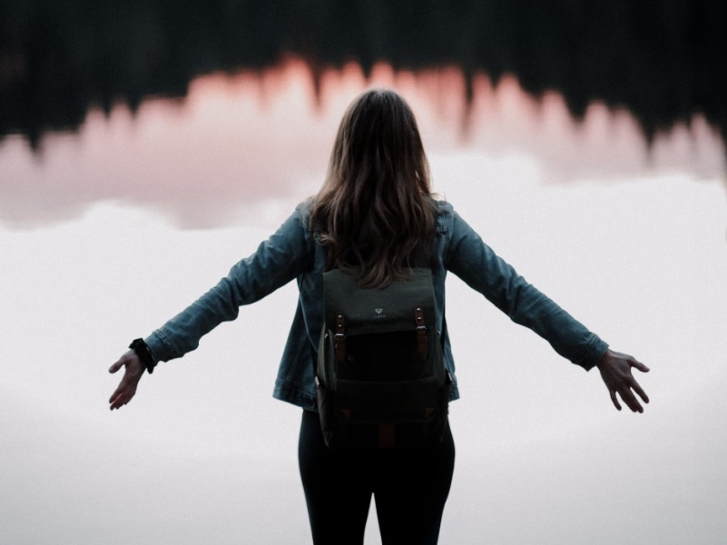 woman standing in front of lake