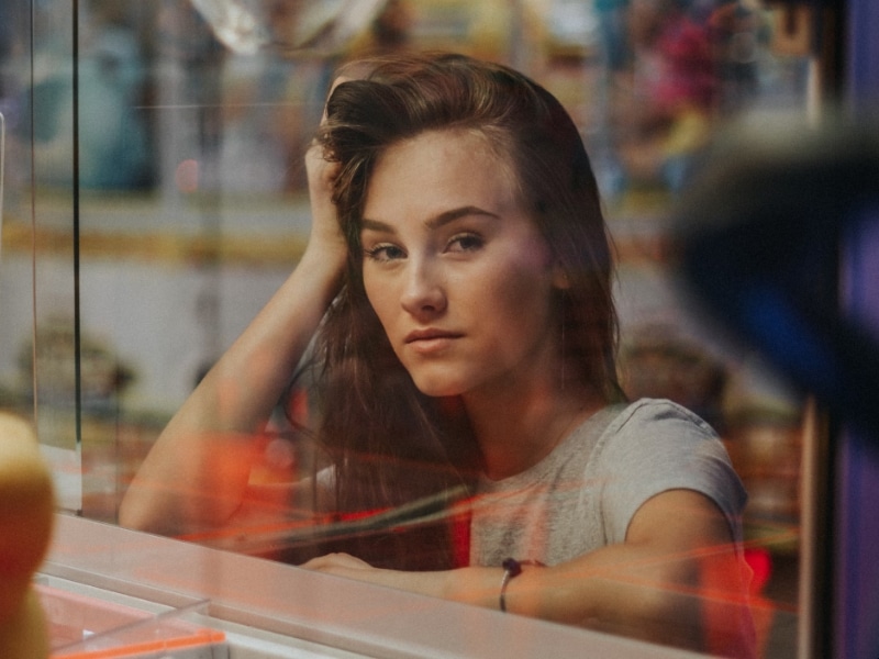 woman staring through glass