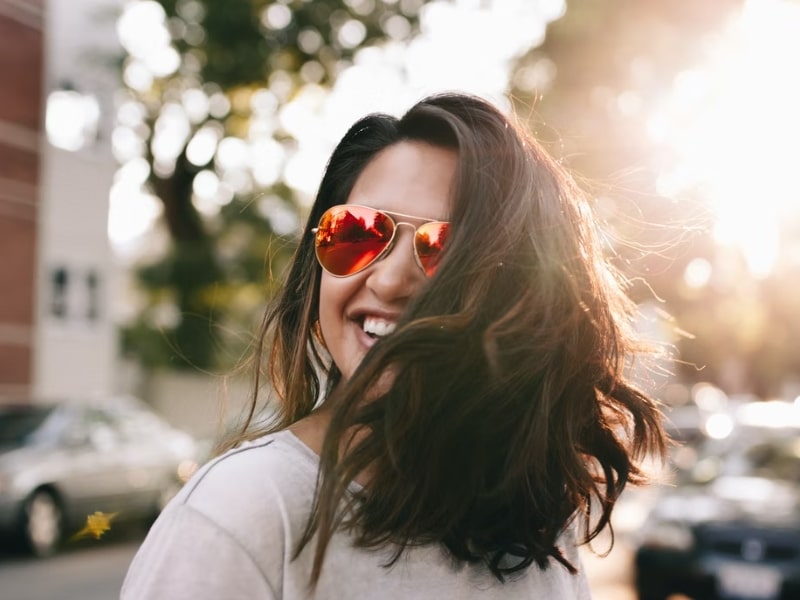 girl smiling with sunglasses