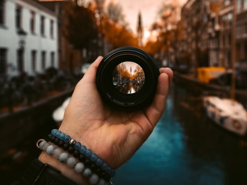 person holding focused lens