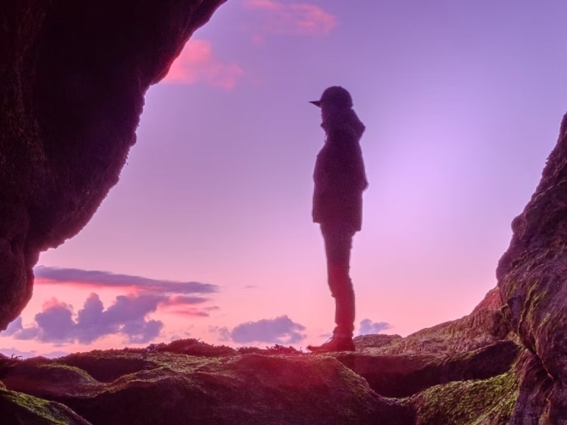 person standing in front of purple sky