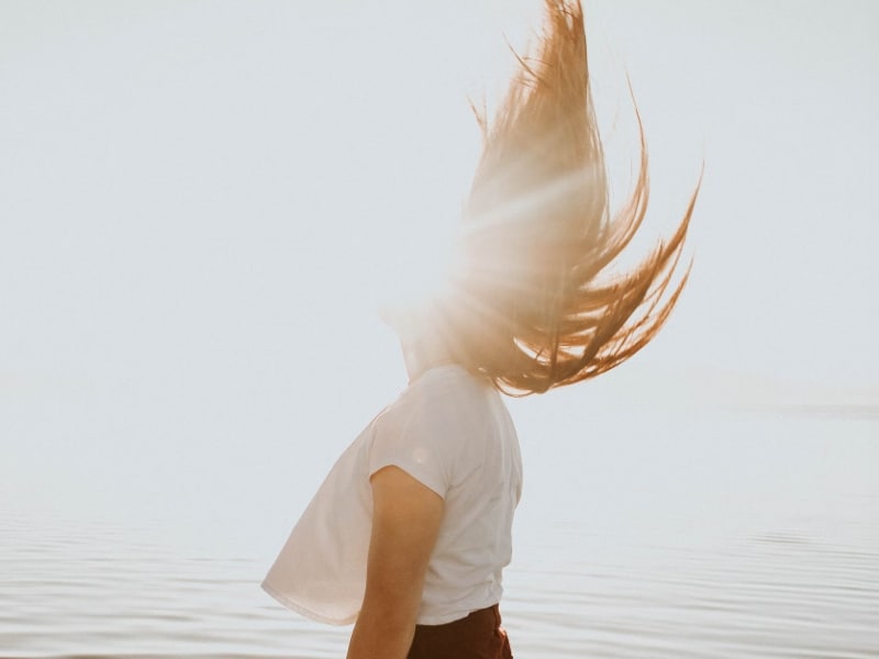 woman swaying hair in sun