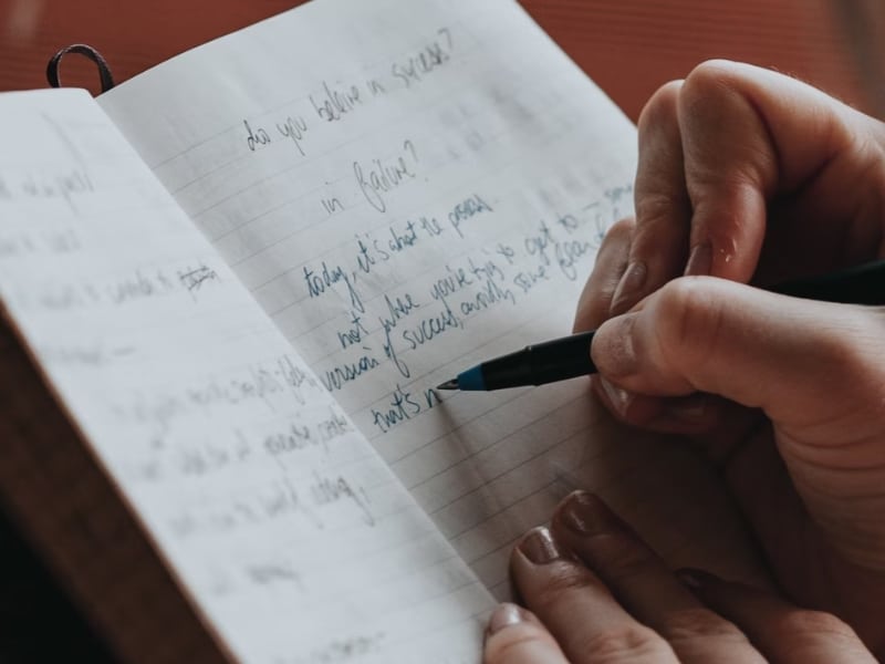 woman writing in journal