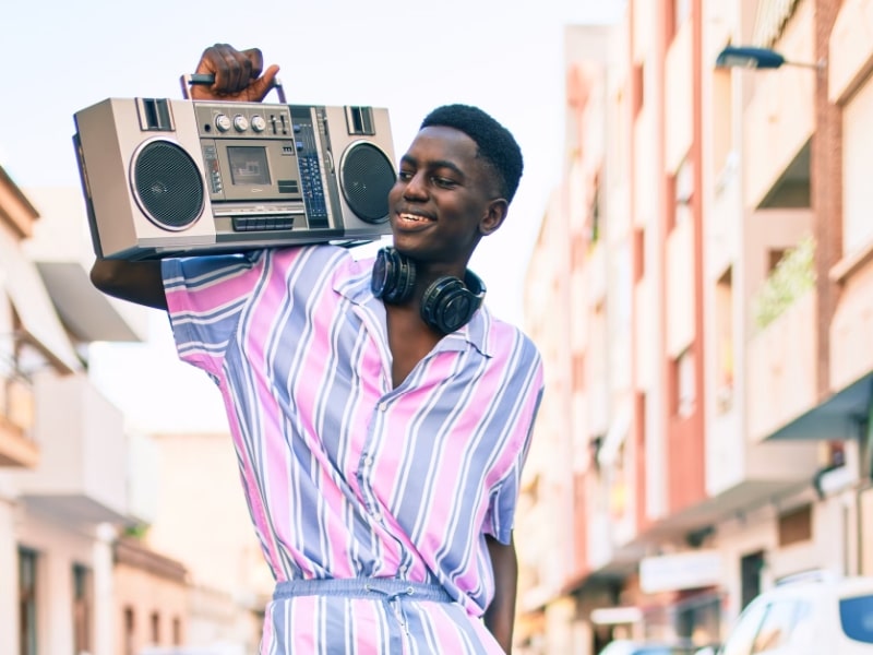man smiling with stereo radio