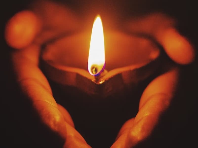 person holding candle in hands