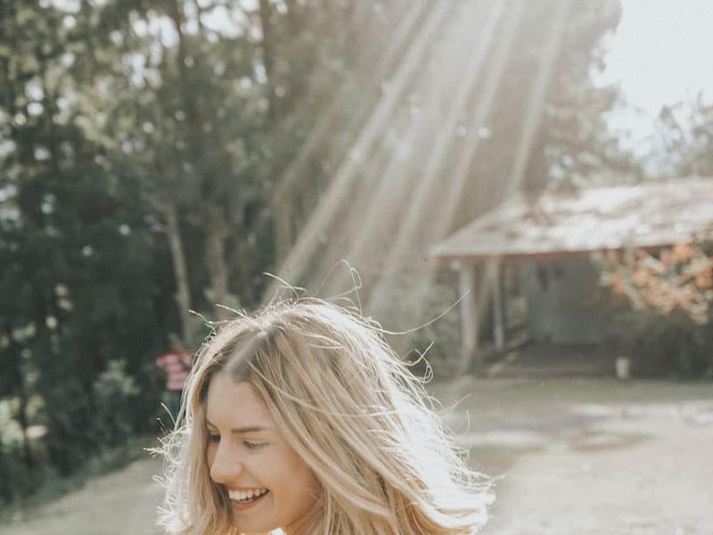 woman smiling outside in sun