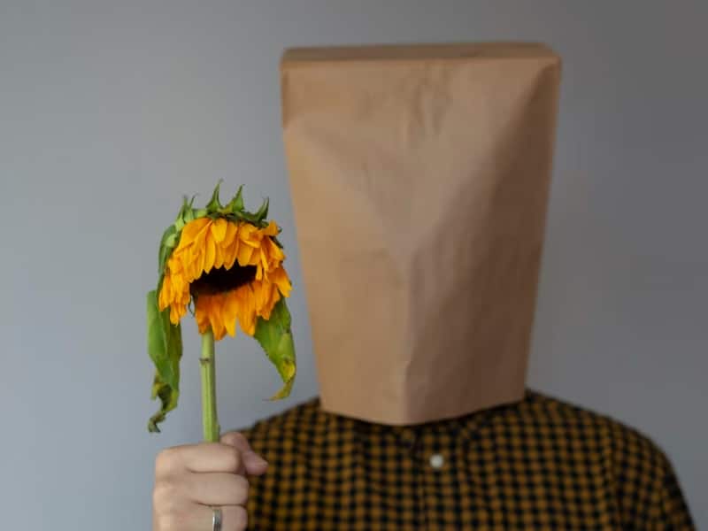 person with paper bag over head