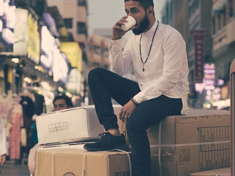 man sitting on top of boxes