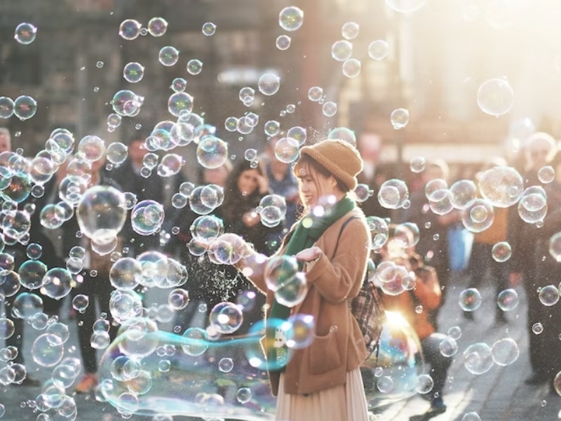 woman blowing bubbles outside