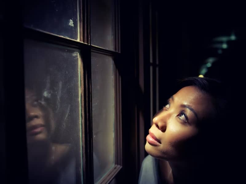 woman looking up out of window