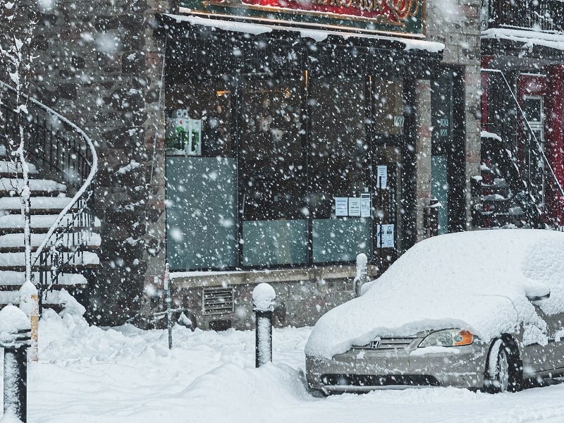 car on street covered in snow