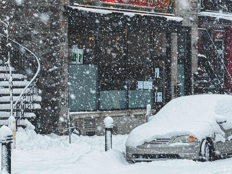 car on street covered in snow