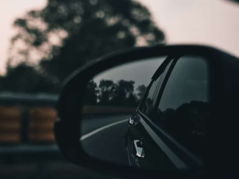 looking back in rear view mirror of car