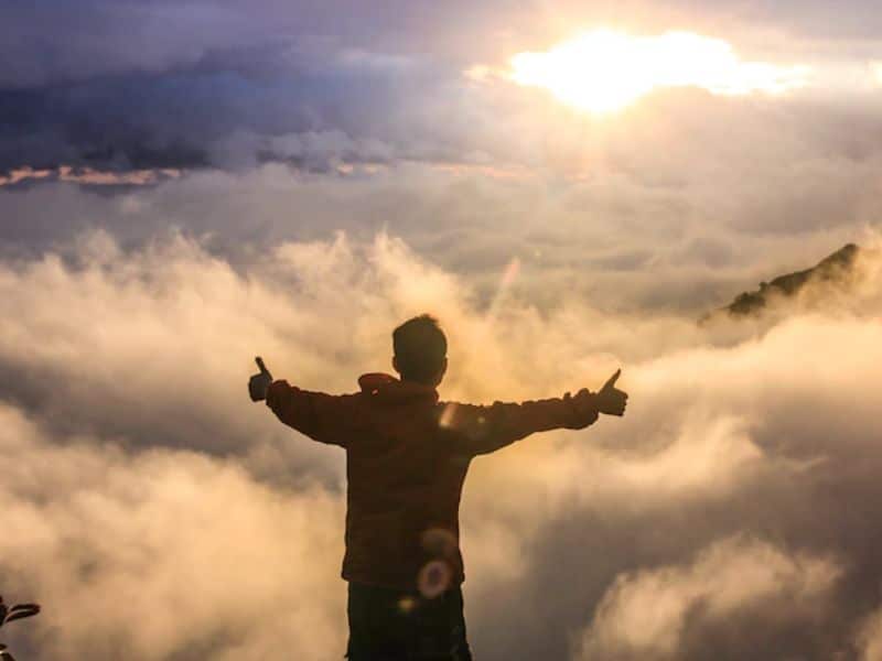 happy man facing clouds