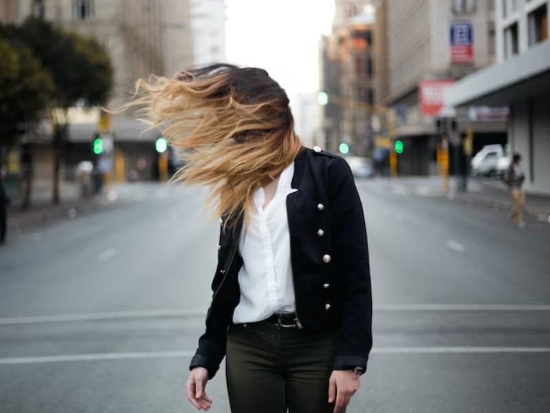 woman with windy hair on street