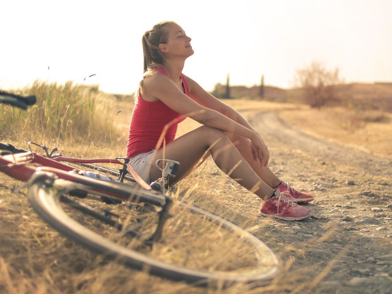 happy while sitting besides bicycle