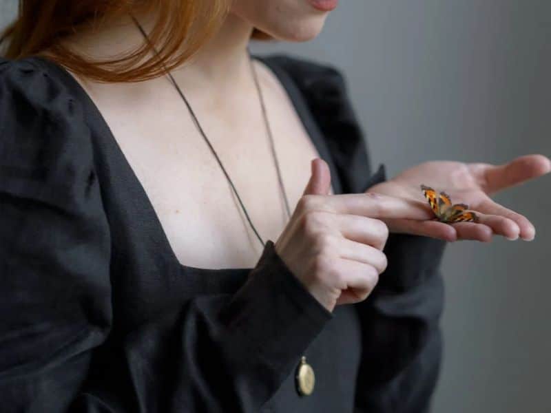 women touching a butterfly