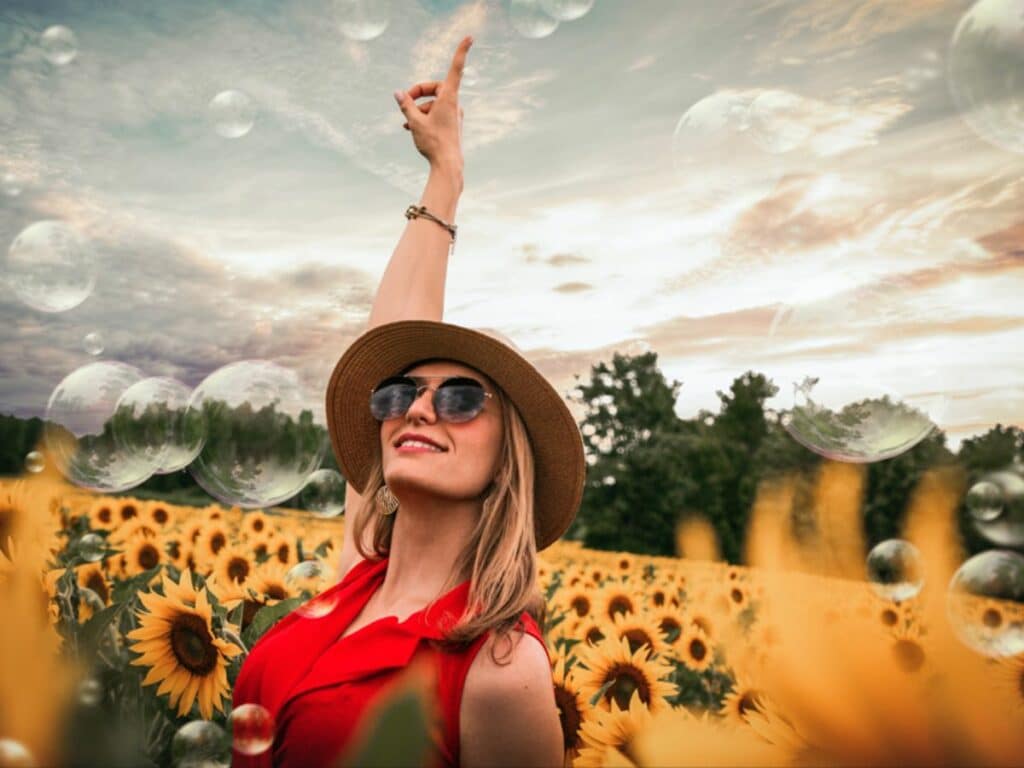 cheerful women in sunflower field