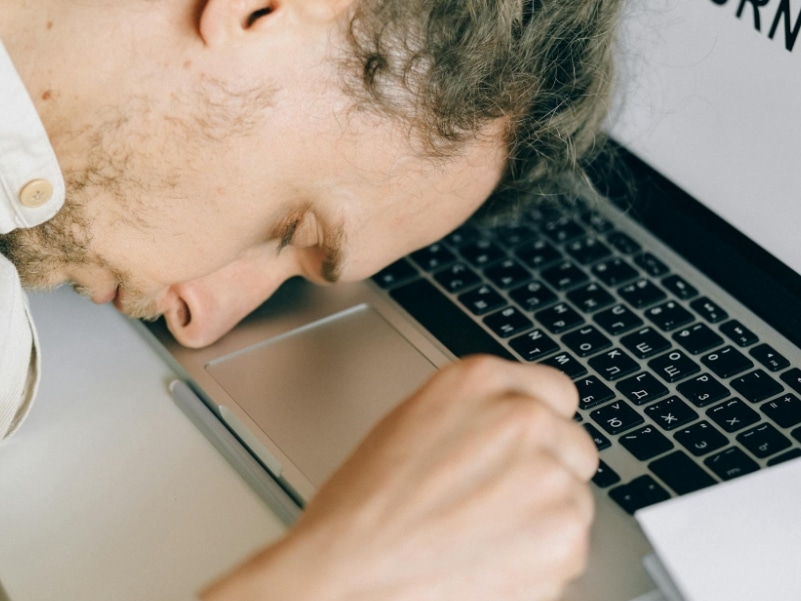 man sleeping on laptop